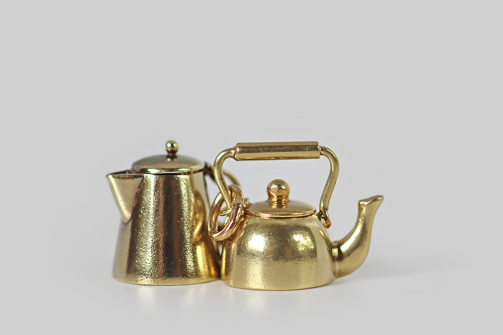 Poor Mouchette | Curated Antique Jewelry, Vintage Jewelry & Engagement Rings | Portland, Oregon | An adorable vintage coffee pot charm, created in 14k yellow gold, by the well-known New York Jewelers Sloan & Co. This miniature coffee pot is a vessel (like a real coffee pot), with a tapering cylindrical form, a triangular spout, and a tiny, perfectly-fitted lid! This little lid comes off the pot's top opening, and is secured to the handle with a very small connecting ring.