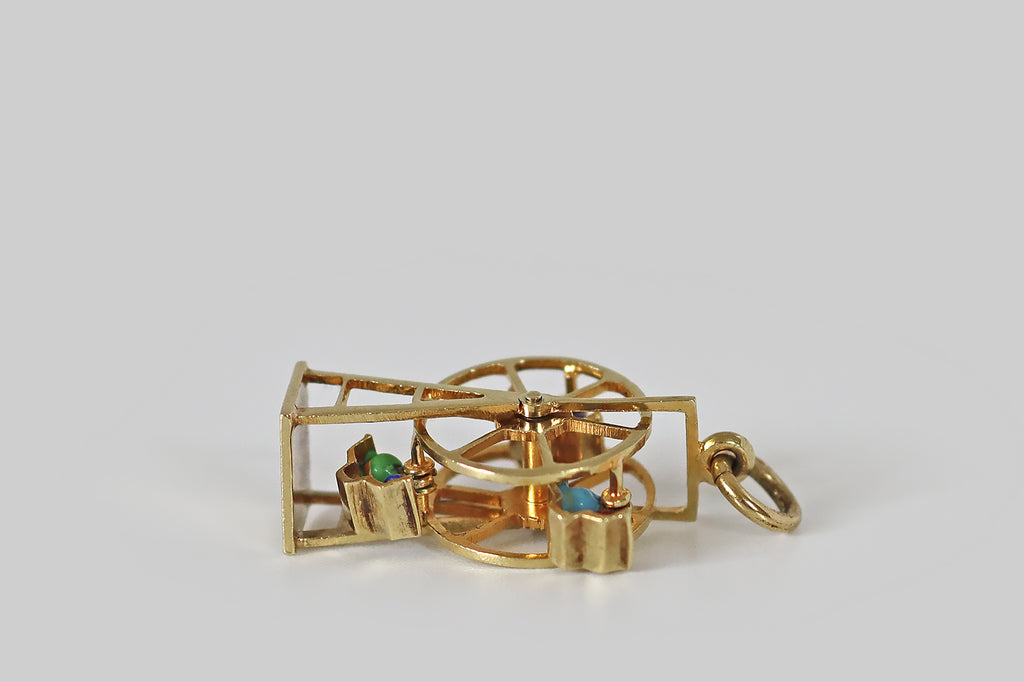 Antique Jewelry Portland, Vintage Jewelry Portland , Antique Engagement Rings | Poor Mouchette | An adorable vintage ferris wheel charm, fabricated in 14k yellow gold, by the well-known New York Jewelers Sloan &amp; Co. This miniature ferris wheel spins freely around a central shaft. Tiny couples, decorated with blue, green, red, and turquoise enamel, tip back and forth in their seats, when the wheel turns. 
