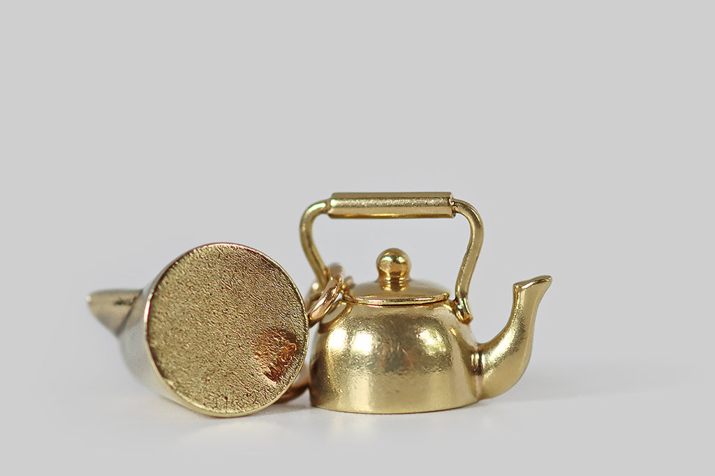 Poor Mouchette | Curated Antique Jewelry, Vintage Jewelry & Engagement Rings | Portland, Oregon | An adorable vintage teapot charm, created in 14k yellow gold, by the well-known New York Jewelers Sloan &amp; Co. This miniature kettle is a vessel (like a real tea kettle), with a soft round body, a curved spout, and a barrel handle. The tiny lid that sits atop our kettle is perfectly-fitted— it connects to the pot's handle with a very small ring.