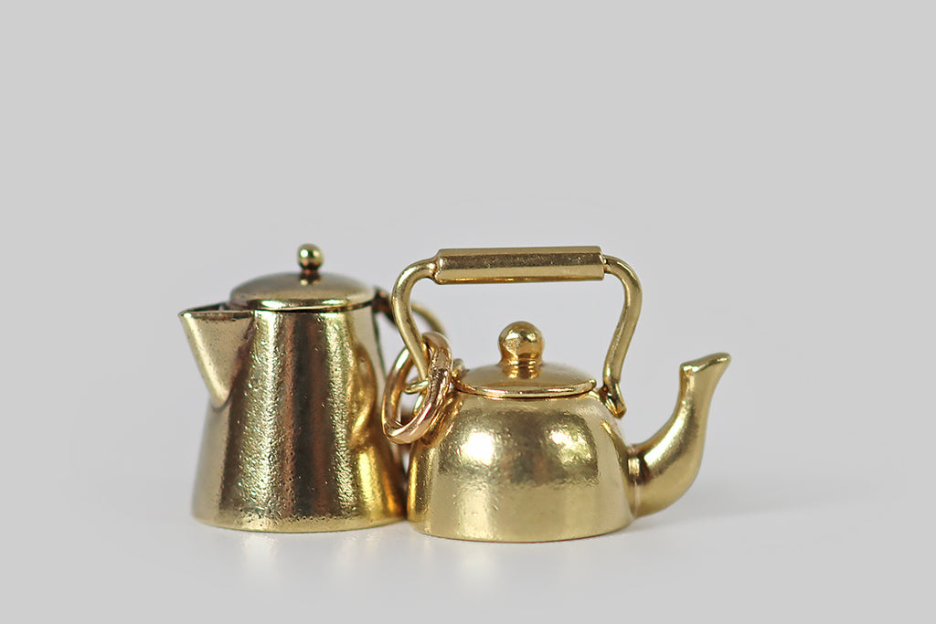Poor Mouchette | Curated Antique Jewelry, Vintage Jewelry & Engagement Rings | Portland, Oregon | An adorable vintage teapot charm, created in 14k yellow gold, by the well-known New York Jewelers Sloan &amp; Co. This miniature kettle is a vessel (like a real tea kettle), with a soft round body, a curved spout, and a barrel handle. The tiny lid that sits atop our kettle is perfectly-fitted— it connects to the pot's handle with a very small ring.