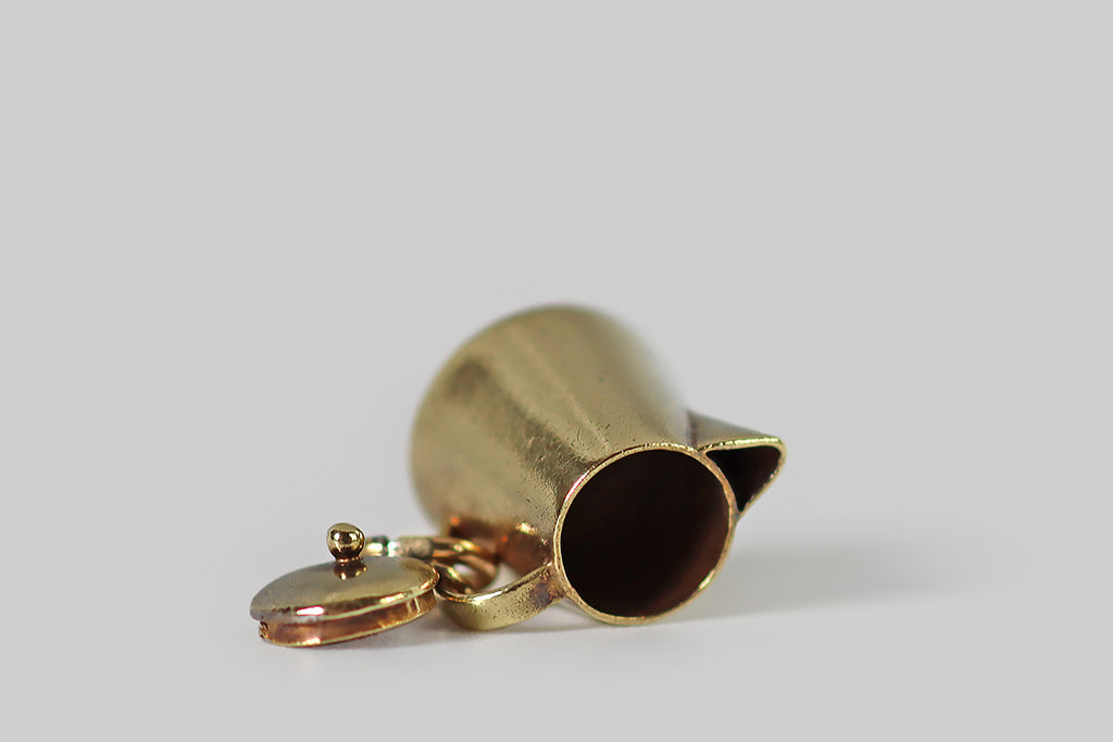 Poor Mouchette | Curated Antique Jewelry, Vintage Jewelry & Engagement Rings | Portland, Oregon | An adorable vintage coffee pot charm, created in 14k yellow gold, by the well-known New York Jewelers Sloan & Co. This miniature coffee pot is a vessel (like a real coffee pot), with a tapering cylindrical form, a triangular spout, and a tiny, perfectly-fitted lid! This little lid comes off the pot's top opening, and is secured to the handle with a very small connecting ring.