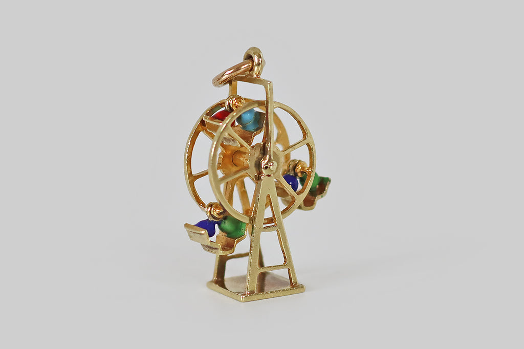 Antique Jewelry Portland, Vintage Jewelry Portland , Antique Engagement Rings | Poor Mouchette | An adorable vintage ferris wheel charm, fabricated in 14k yellow gold, by the well-known New York Jewelers Sloan &amp; Co. This miniature ferris wheel spins freely around a central shaft. Tiny couples, decorated with blue, green, red, and turquoise enamel, tip back and forth in their seats, when the wheel turns. 