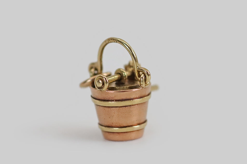 Antique Jewelry Portland, Vintage Jewelry Portland , Antique Engagement Rings | Poor Mouchette | A very rare, miniature, mechanical ice cream maker charm, modeled in 14k gold by the well-known New York jewelers Sloan & Co. This tiny, realistic, bucket-style ice cream maker is made with two rotating, hand-fabricated gears, just like the real thing. The larger gear fits perfectly inside the bucket's opening, while the smaller is attached to the ice cream maker's hand crank