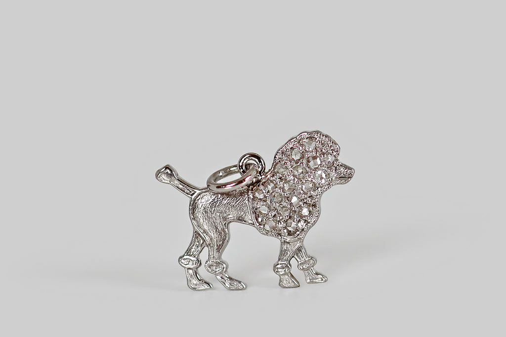 Antique Jewelry Portland, Vintage Jewelry Portland , Antique Engagement Rings | Poor Mouchette | A delicate, Art Deco era poodle charm, modeled in platinum, whose curly head and chest are represented by a bevy of pave-set rose cut diamonds. Our poodle's lower body is shorn, and this texture is represented by fine, graved lines.