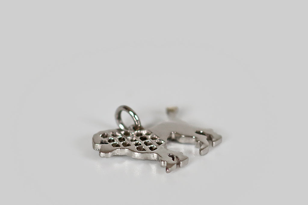 Antique Jewelry Portland, Vintage Jewelry Portland , Antique Engagement Rings | Poor Mouchette | A delicate, Art Deco era poodle charm, modeled in platinum, whose curly head and chest are represented by a bevy of pave-set rose cut diamonds. Our poodle's lower body is shorn, and this texture is represented by fine, graved lines.