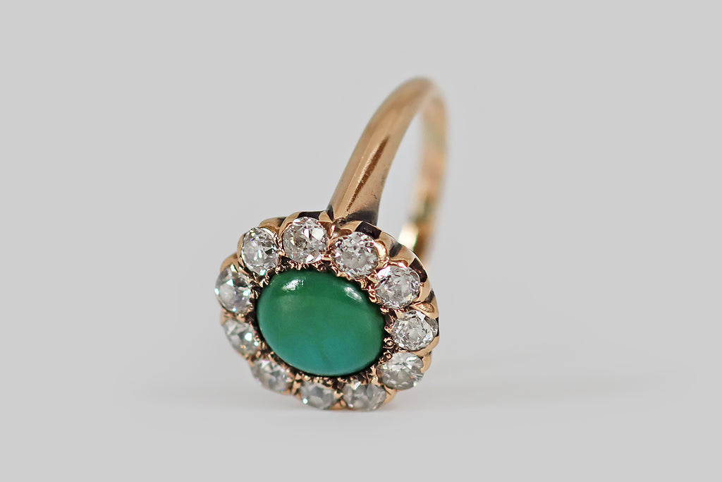 Antique Jewelry Portland, Vintage Jewelry Portland , Antique Engagement Rings | Poor Mouchette | A low-profile, Victorian era cluster ring, modeled in 14k rosy yellow gold, whose central, turquoise gemstone is encircled by a halo of eleven old European cut diamonds. This turquoise is green-blue, with subtle, nebulous variegation. It has acquired a beautiful, silky, jade-like lustre, in the course of its life. The surrounding, chunky OEC diamonds are bright and lively (H/I, VS1-SI1)