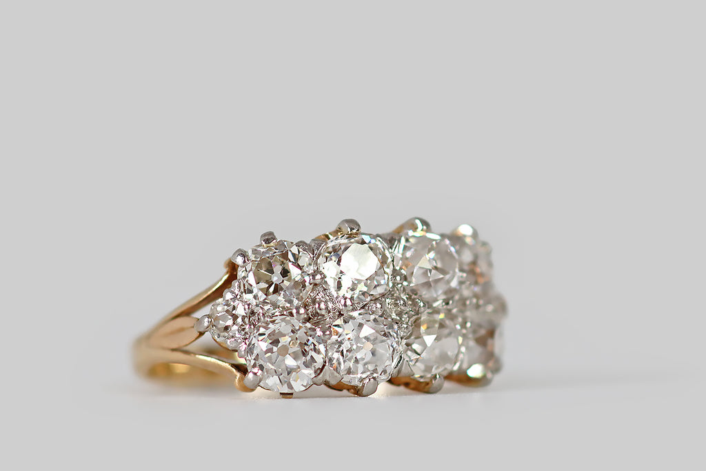 Poor Mouchette | Curated Antique Jewelry, Vintage Jewelry & Engagement Rings | Portland, Oregon | An Edwardian era engagement ring, modeled in 14k rosy yellow gold and platinum. This low-profile ring features eight, chunky, old European cut diamonds, which are arranged in a double row across its face. These two rows of four diamonds are set in platinum, in a combination of beads and prongs, giving the ring face a sparkling, all-white appearance.