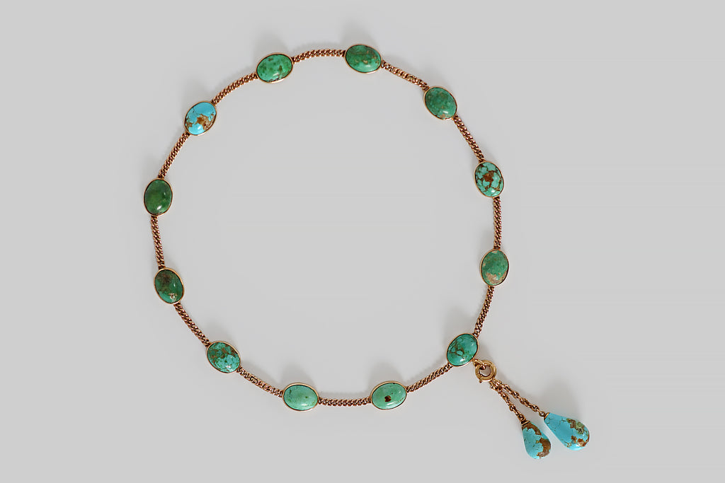Poor Mouchette | Curated Antique Jewelry, Vintage Jewelry & Engagement Rings | Portland, Oregon | A rare and wonderful Victorian-era convertible jewelry suite, modeled in 14k yellow gold, featuring a series of natural, untreated turquoise cabochons, in shades of blue and green. These turquoise cabs are bezel-set and stationed along lengths of flattened curb-link chain. The suite can be worn as a pair of bracelets, or as a necklace, thanks to a pair of ingenious hidden clasps that create a seamless 