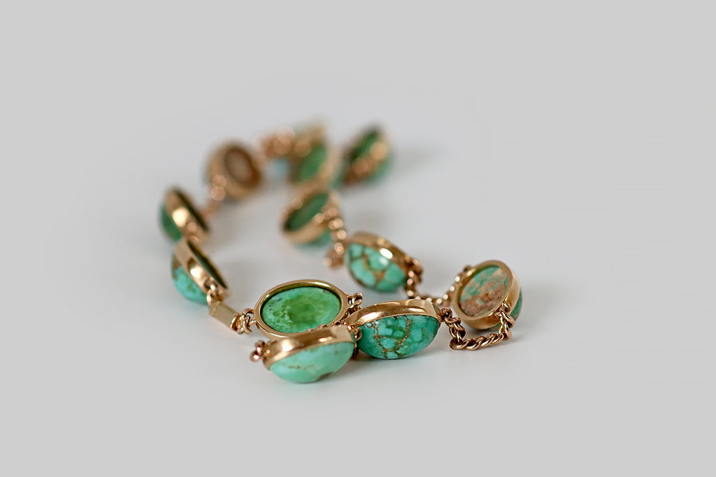 Poor Mouchette | Curated Antique Jewelry, Vintage Jewelry & Engagement Rings | Portland, Oregon | A rare and wonderful Victorian-era convertible jewelry suite, modeled in 14k yellow gold, featuring a series of natural, untreated turquoise cabochons, in shades of blue and green. These turquoise cabs are bezel-set and stationed along lengths of flattened curb-link chain. The suite can be worn as a pair of bracelets, or as a necklace, thanks to a pair of ingenious hidden clasps that create a seamless 