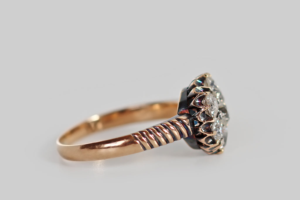 Poor Mouchette | Curated Antique Jewelry, Vintage Jewelry & Engagement Rings | Portland, Oregon | A Victorian-era cluster ring, modeled in 14k rosy yellow gold, whose diamonds are arranged to suggest a six-petaled flower. This diamond flower is composed of seven old mine and old European cut diamonds— a central OEC (approx .27 carats) surrounded by a series of mixed old cuts.