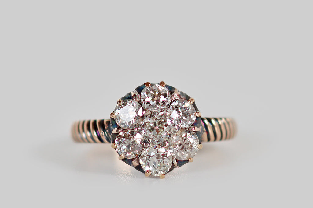 Poor Mouchette | Curated Antique Jewelry, Vintage Jewelry & Engagement Rings | Portland, Oregon | A Victorian-era cluster ring, modeled in 14k rosy yellow gold, whose diamonds are arranged to suggest a six-petaled flower. This diamond flower is composed of seven old mine and old European cut diamonds— a central OEC (approx .27 carats) surrounded by a series of mixed old cuts.