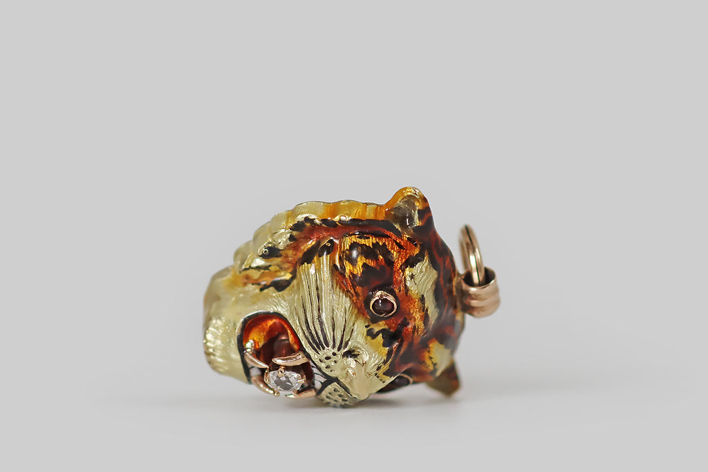 Antique Jewelry Portland, Vintage Jewelry Portland , Antique Engagement Rings | Poor Mouchette | A scarce, Victorian-era, three-dimensional tiger mask pendant, modeled in 14k gold and beautifully painted with vitreous, polychrome enamel, in various shades of red, orange, brown, yellow, black, and white. This tiger is especially handsome, and he is highly-detailed. He wears an intense expression, and holds a small old mine cut diamond