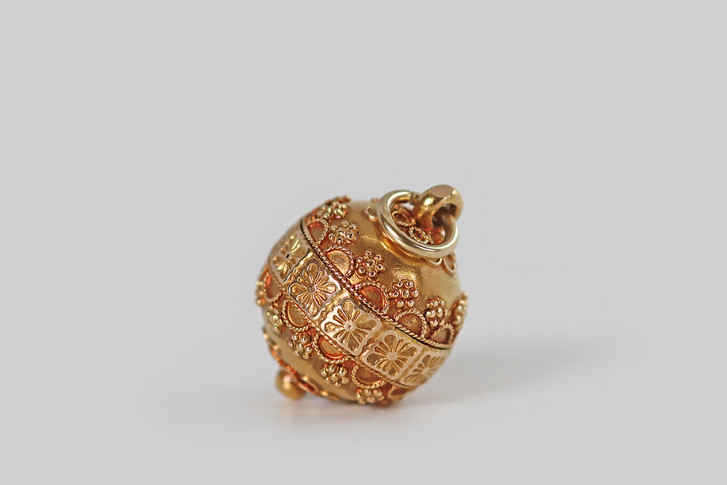 Antique Jewelry Portland, Vintage Jewelry Portland , Antique Engagement Rings | Poor Mouchette | A charming, Victorian-era, orb-shaped pendant, modeled in 14k yellow gold and finished with a rich, high-color bloom. This small orb is decorated, all over, with twisted wirework, and fine granulation that coalesces around the orb's primary feature— a band of tiles, with flower decor, that spans its meridian.