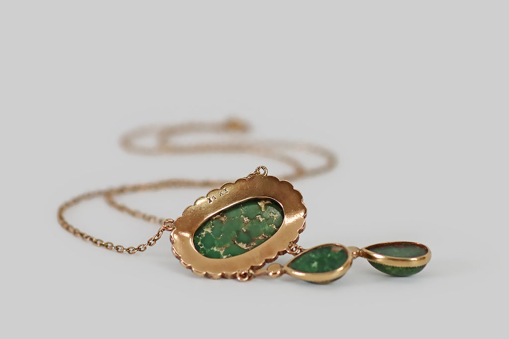 Antique Jewelry Portland, Vintage Jewelry Portland , Antique Engagement Rings | Poor Mouchette | A soulful Victorian era necklace, modeled in 14k rosy yellow gold, whose central element is a large, green turquoise cabochon (oval, oriented east/west). This natural, olive-green turquoise is beautifully figured with tan matrix. It rests in a delicately-toothed bezel, where it is surrounded by a scalloped border, set with a series of silvery-white seed pearls.