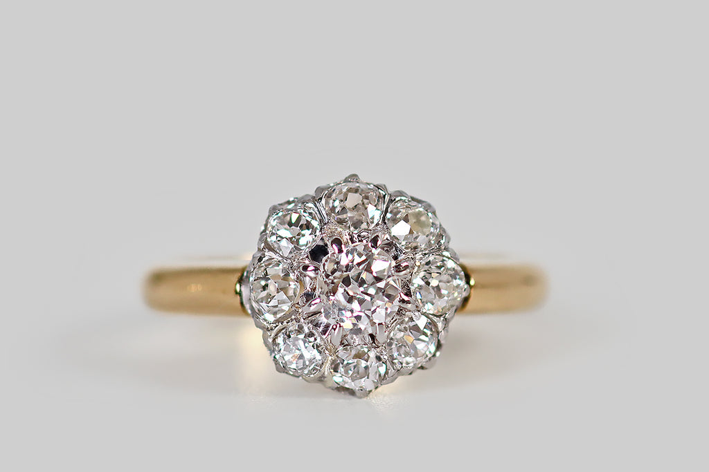 Poor Mouchette | Curated Antique Jewelry, Vintage Jewelry & Engagement Rings | Portland, Oregon | A lovely, Edwardian-era, old cut diamond halo ring, modeled in 18k yellow gold and platinum, whose form calls to mind an eight-petaled flower. This French cluster's primary gem is a chunky old mine cut diamond (approx .33 carats). This central diamond is surrounded by a bevy of old European cut diamonds