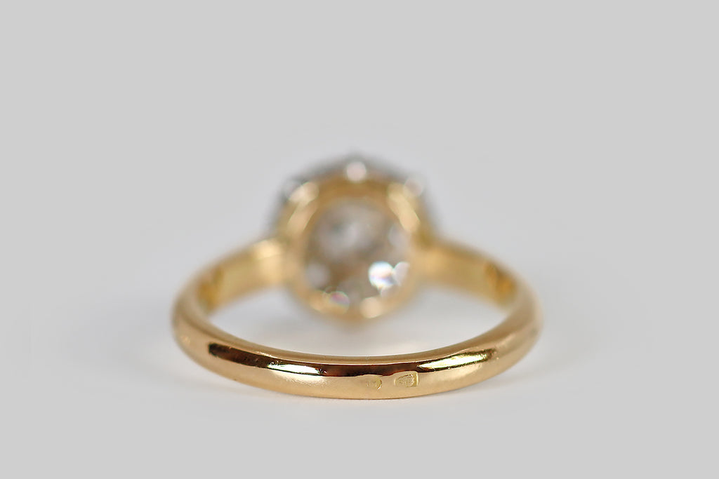 Poor Mouchette | Curated Antique Jewelry, Vintage Jewelry & Engagement Rings | Portland, Oregon | A lovely, Edwardian-era, old cut diamond halo ring, modeled in 18k yellow gold and platinum, whose form calls to mind an eight-petaled flower. This French cluster's primary gem is a chunky old mine cut diamond (approx .33 carats). This central diamond is surrounded by a bevy of old European cut diamonds