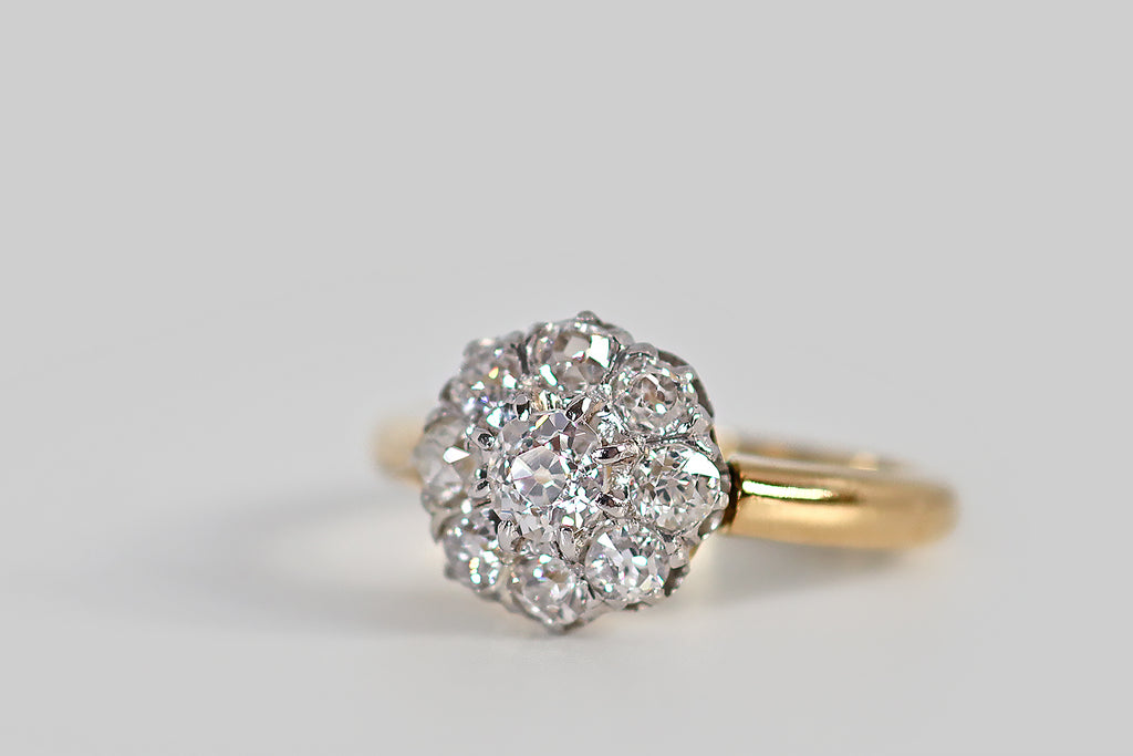 Poor Mouchette | Curated Antique Jewelry, Vintage Jewelry & Engagement Rings | Portland, Oregon | A lovely, Edwardian-era, old cut diamond halo ring, modeled in 18k yellow gold and platinum, whose form calls to mind an eight-petaled flower. This French cluster's primary gem is a chunky old mine cut diamond (approx .33 carats). This central diamond is surrounded by a bevy of old European cut diamonds