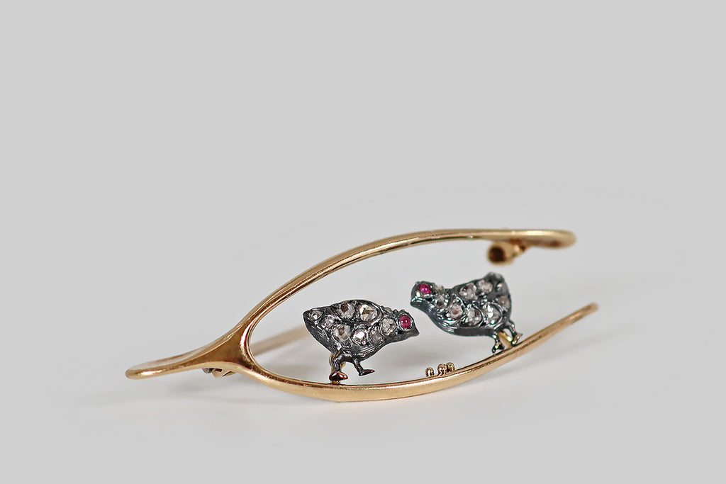Antique Jewelry Portland, Vintage Jewelry Portland , Antique Engagement Rings | Poor Mouchette | A Victorian era brooch, modeled in 14k yellow gold and silver, made to resemble a wishbone that frames a pair of sweet, diamond-encrusted chicks. These chicks have chubby, silver bodies, and little gold feet— each chick has a cabochon ruby eye, and they are both covered with small, pave-set, rose cut diamonds that read like sparkling feathers!