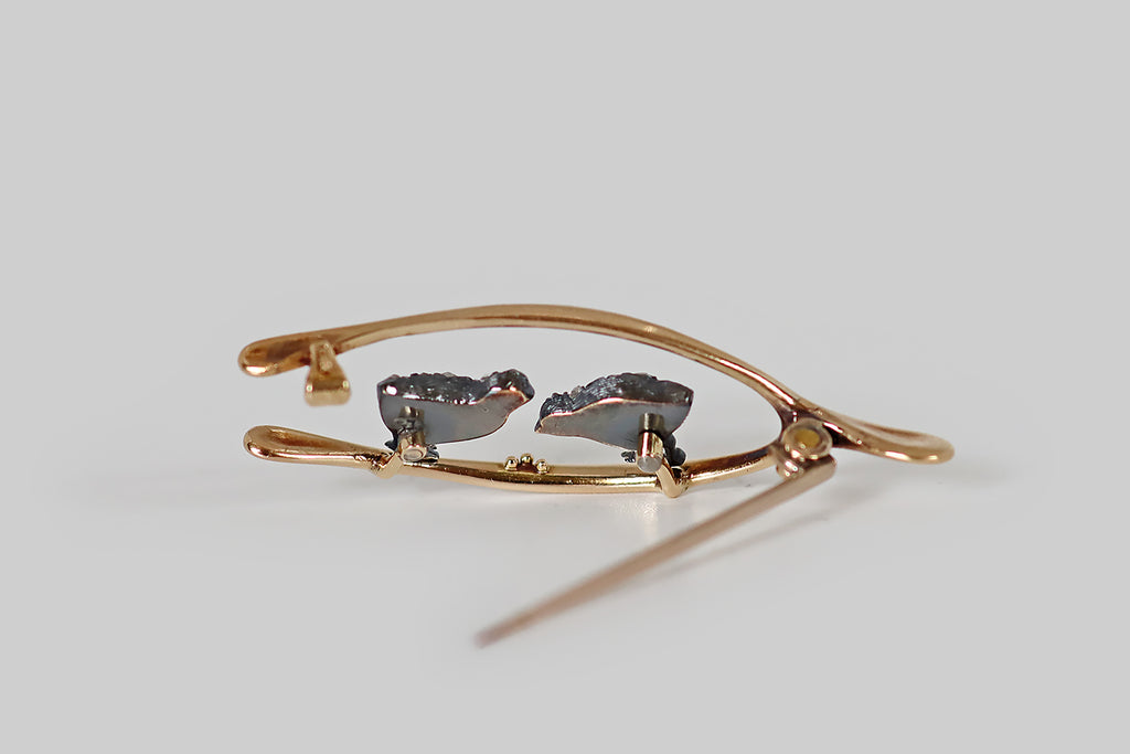Antique Jewelry Portland, Vintage Jewelry Portland , Antique Engagement Rings | Poor Mouchette | A Victorian era brooch, modeled in 14k yellow gold and silver, made to resemble a wishbone that frames a pair of sweet, diamond-encrusted chicks. These chicks have chubby, silver bodies, and little gold feet— each chick has a cabochon ruby eye, and they are both covered with small, pave-set, rose cut diamonds that read like sparkling feathers!
