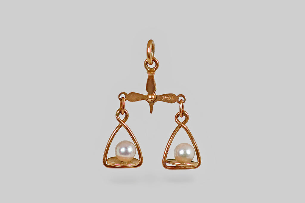 Antique Jewelry Portland, Vintage Jewelry Portland , Antique Engagement Rings | Poor Mouchette | A dainty, vintage, articulated charm, modeled in 14k yellow gold, to resemble a pair of balance scales, with white, cultured-pearl weights. These tiny scales have pans that tip up and down, thanks to a beautifully-made, riveted apex that connects the scale's pillar and beam. This is a wondrous little object and it is beautifully made! 
