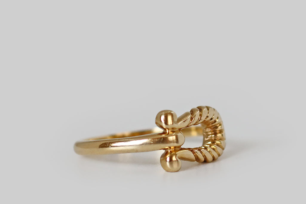 Antique Jewelry Portland, Vintage Jewelry Portland , Antique Engagement Rings | Poor Mouchette | A vintage ring, modeled in 14k yellow gold, whose form was inspired by a viking-style fibula. Here, the ring face is an open omega-shaped form, with twisted, rope-like details. The ends of our ribbed fibula are curled, and the ring's slender shank joins the face, at its base, between these curls. 