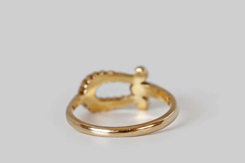 Antique Jewelry Portland, Vintage Jewelry Portland , Antique Engagement Rings | Poor Mouchette | A vintage ring, modeled in 14k yellow gold, whose form was inspired by a viking-style fibula. Here, the ring face is an open omega-shaped form, with twisted, rope-like details. The ends of our ribbed fibula are curled, and the ring's slender shank joins the face, at its base, between these curls. 