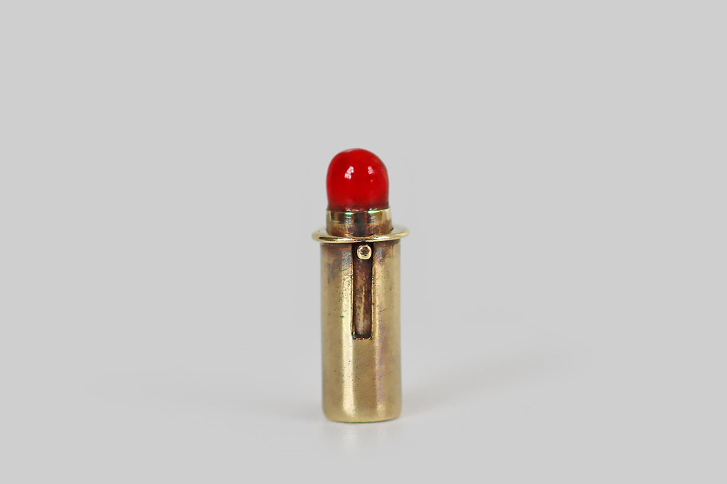 Antique Jewelry Portland, Vintage Jewelry Portland , Antique Engagement Rings | Poor Mouchette | A very cool, moveable, miniature charm, modeled in 14k yellow gold by the well-known New York jewelers Sloan & Co. This tiny hand-fabricated charm is made to resemble a tube of lipstick. Push the charm's button plunger upwards, and a knob of bright red enameled lipstick emerges from its gold case; push it down, and the make-up returns to the tube!