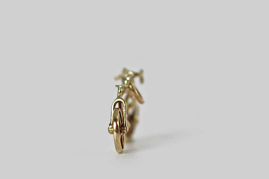 Poor Mouchette | Curated Antique Jewelry, Vintage Jewelry & Engagement Rings | Portland, Oregon | A sweet miniature bicycle charm, fabricated in 14k yellow gold by the well-known New York jewelers Sloan &amp; Co. This tiny bicycle is admirably made, with a delicate frame, miniature pedals, and spoked wheels that rotate freely.