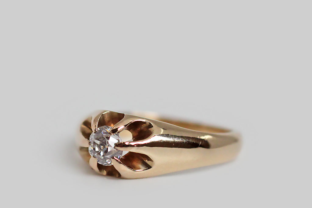 A charming, Victorian-era, Belcher claw ring, modeled in 14k yellow gold, whose six, tapering prongs hold a glittering, .30 carat, old mine cut diamond. The belcher setting is a simple, elegant style, named for its creator, Thomas Belcher— this one is especially graceful, with long, rounded, cutaway sections that give the ring face a floral appearance and create an abundance of light behind its diamond.