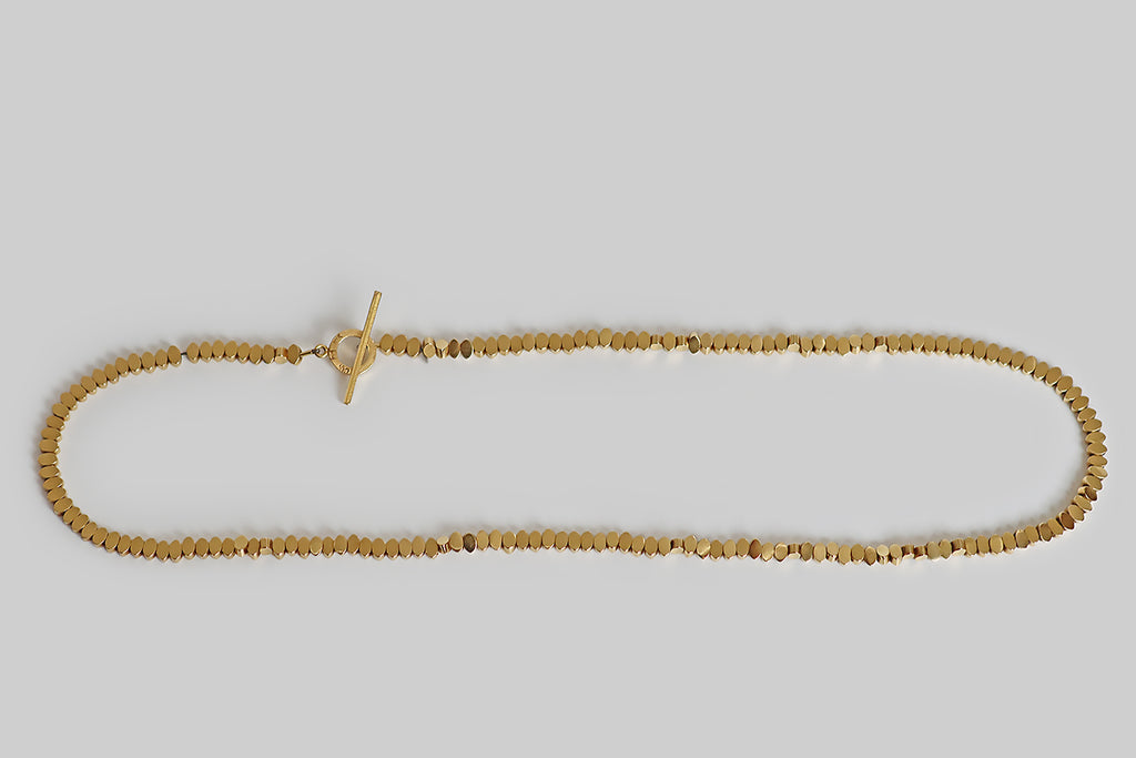 Poor Mouchette | Curated Antique Jewelry, Vintage Jewelry & Engagement Rings | Portland, Oregon | A very cool, late-vintage, 18k yellow gold necklace, composed of hand-finished (filed and polished), navette-shaped beads. These individually cast beads are plump, with flat faces, straight sides, and gently rounded points— they spin freely on their slender cable, creating subtle, shining texture and illusory variation in form.