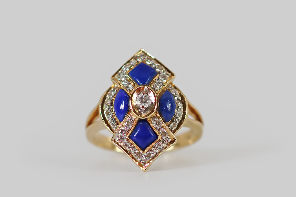 Poor Mouchette | Curated Antique Jewelry, Vintage Jewelry & Engagement Rings | Portland, Oregon | A bold, graphic, vintage ring, modeled in 18k yellow gold, whose arabesque face is set with four, shapely lapis lazuli cabochons. These vibrant blue lapis cabochons are bordered by bead-set diamond surrounds, which further define the arabesque form, creating lovely dimensionality.