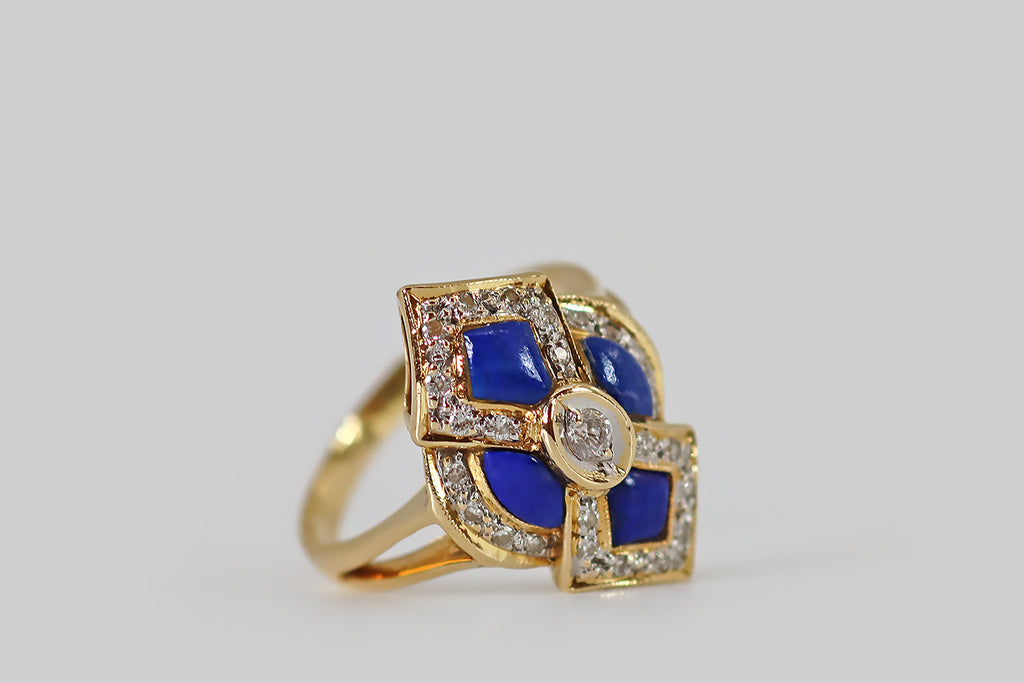 Poor Mouchette | Curated Antique Jewelry, Vintage Jewelry & Engagement Rings | Portland, Oregon | A bold, graphic, vintage ring, modeled in 18k yellow gold, whose arabesque face is set with four, shapely lapis lazuli cabochons. These vibrant blue lapis cabochons are bordered by bead-set diamond surrounds, which further define the arabesque form, creating lovely dimensionality.