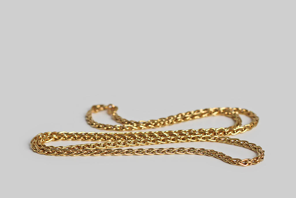 Poor Mouchette | Curated Antique Jewelry, Vintage Jewelry & Engagement Rings | Portland, Oregon | A weighty, 18k yellow gold, foxtail-link chain, manufactured by the Italian makers, Balestra. This 20" chain is comprised of solid, looping links that overlap in a braid-like manner. This is luxurious, but not ostentatious— it has a perfectly fluid hand, and lays beautifully in wear. 
