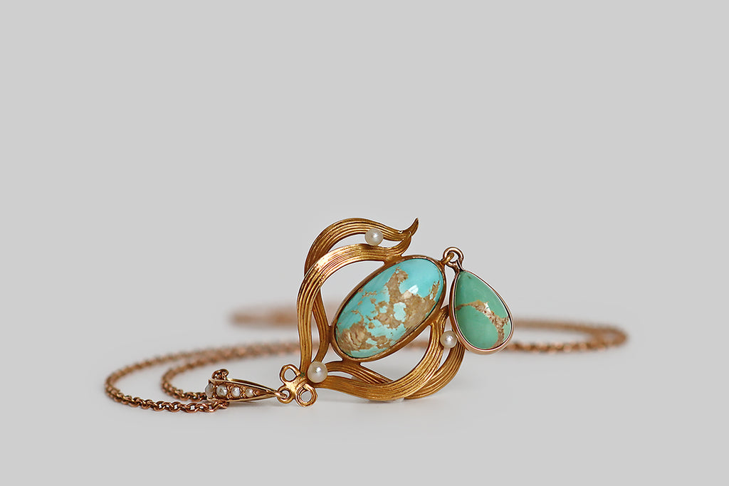 Poor Mouchette | Curated Antique Jewelry, Vintage Jewelry & Engagement Rings | Portland, Oregon | A lovely Art Nouveau era lavaliere necklace, modeled in 10k rosy yellow gold, whose pendant features two natural, bezel-set, turquoise cabochons— a robin’s egg blue oval, that rests inside the pendant's shapely gold frame, and a slightly greener (sea foam) pear, that drops below this frame. These turquoise cabochons are vibrant and highly-silicated, with a high polish, and striking light-brown matrix. 