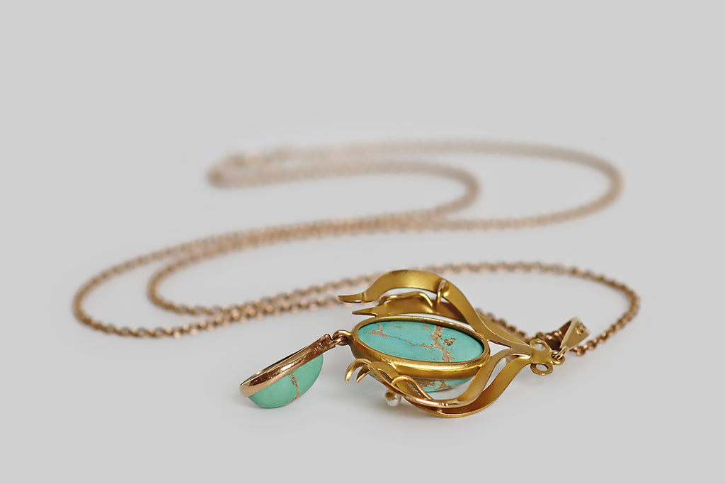 Poor Mouchette | Curated Antique Jewelry, Vintage Jewelry & Engagement Rings | Portland, Oregon | A lovely Art Nouveau era lavaliere necklace, modeled in 10k rosy yellow gold, whose pendant features two natural, bezel-set, turquoise cabochons— a robin’s egg blue oval, that rests inside the pendant's shapely gold frame, and a slightly greener (sea foam) pear, that drops below this frame. These turquoise cabochons are vibrant and highly-silicated, with a high polish, and striking light-brown matrix.
