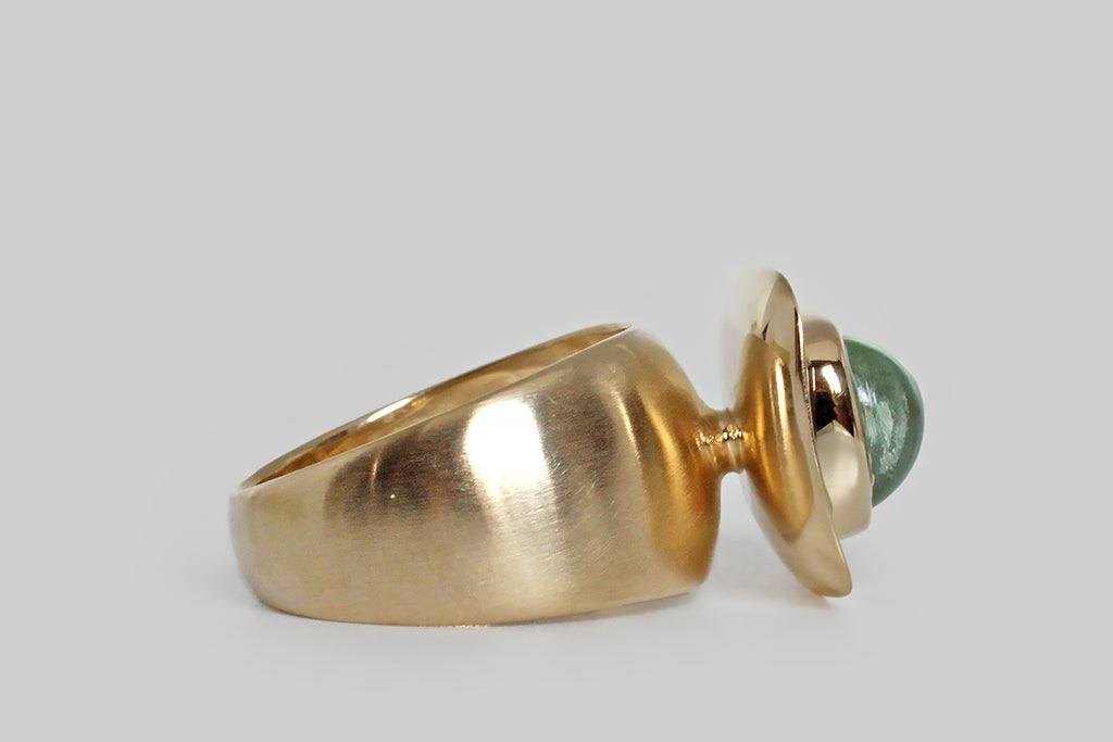 Poor Mouchette | Curated Antique Jewelry, Vintage Jewelry & Engagement Rings | Portland, Oregon | A contemporary modernist ring of our own design, featuring an anticlastic, dish-like head, and a broad, tapering, synclastic shank. A plump, lozenge-shaped, aquamarine cabochon sits at the center of the ring's softly-rectangular face, in a smooth bezel. We think this shallow platter, and it's glowing gem, give the impression of an offering (palms up)!