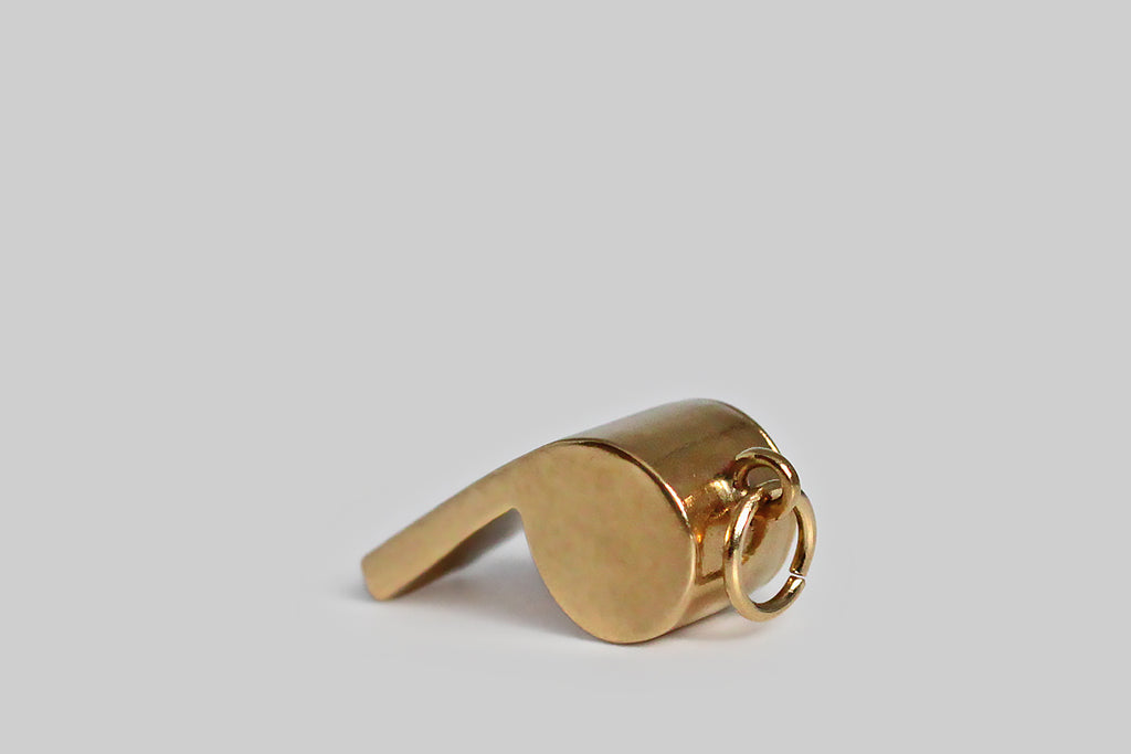 Poor Mouchette | Curated Antique Jewelry, Vintage Jewelry & Engagement Rings | Portland, Oregon | A dainty, mid 20th century charm, modeled in 14k yellow gold, as functioning, drill-style whistle. This tiny whistle is beautifully and substantially made, in the classic shape favored by coaches, police officers, and dog trainers, and it makes a soft, high-pitched sound when you blow it.