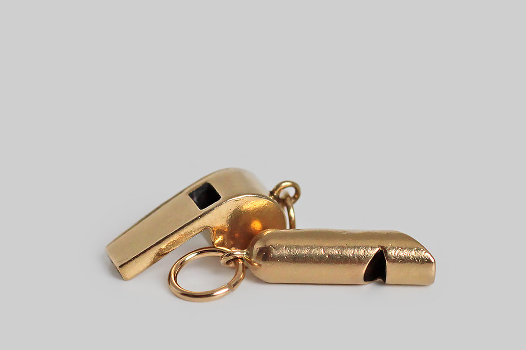 Poor Mouchette | Curated Antique Jewelry, Vintage Jewelry & Engagement Rings | Portland, Oregon | A dainty, mid 20th century charm, modeled in 14k yellow gold, as functioning, drill-style whistle. This tiny whistle is beautifully and substantially made, in the classic shape favored by coaches, police officers, and dog trainers, and it makes a soft, high-pitched sound when you blow it.
