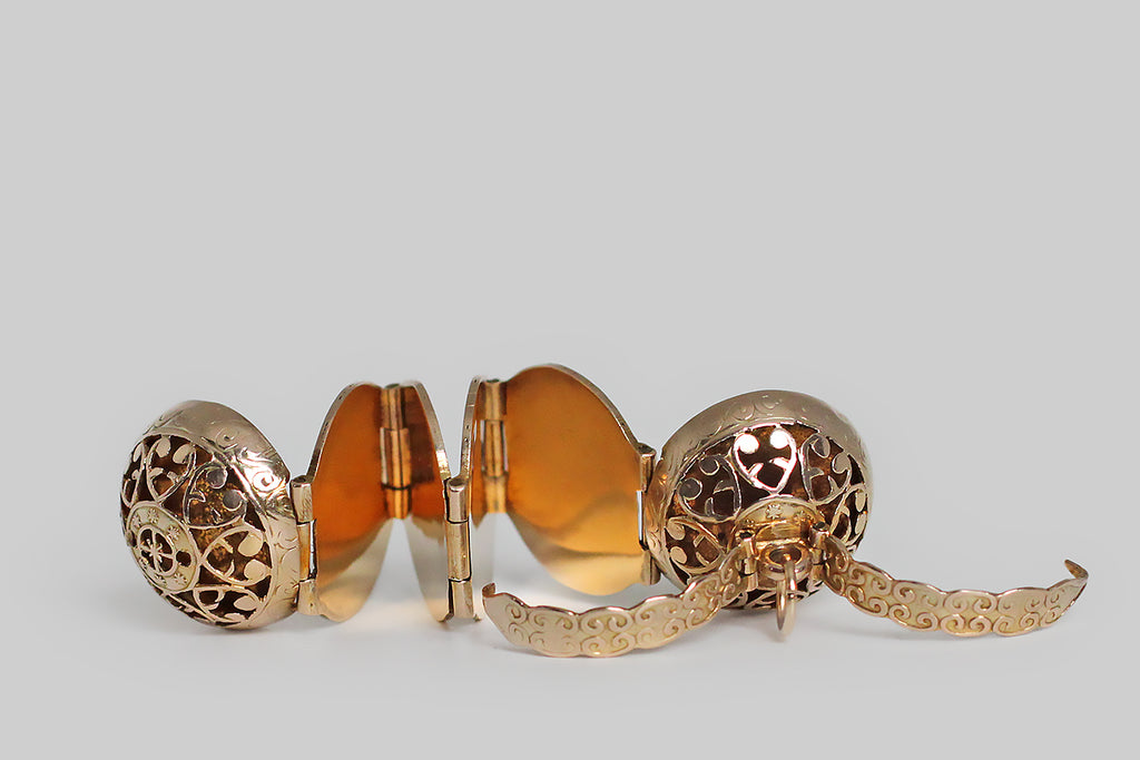 Poor Mouchette | Curated Antique Jewelry, Vintage Jewelry & Engagement Rings | Portland, Oregon | A clever, Victorian era, multi-photo locket, substantially modeled in 14k yellow gold, whose orb-like form is hand-pierced with a series of baroque heart shapes and a central medallion featuring a compass rose. This unusual, unfolding locket is bound by a pair of arms that snap into place, securing the orb