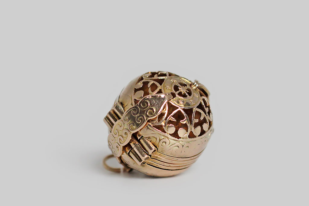 Poor Mouchette | Curated Antique Jewelry, Vintage Jewelry & Engagement Rings | Portland, Oregon | A clever, Victorian era, multi-photo locket, substantially modeled in 14k yellow gold, whose orb-like form is hand-pierced with a series of baroque heart shapes and a central medallion featuring a compass rose. This unusual, unfolding locket is bound by a pair of arms that snap into place, securing the orb
