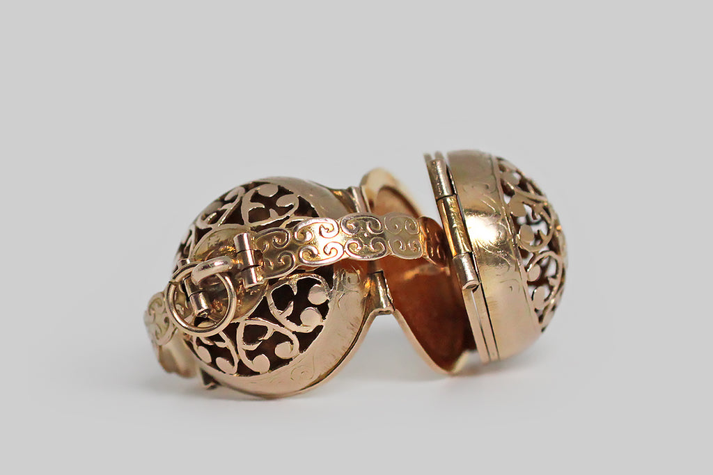 Poor Mouchette | Curated Antique Jewelry, Vintage Jewelry & Engagement Rings | Portland, Oregon | A clever, Victorian era, multi-photo locket, substantially modeled in 14k yellow gold, whose orb-like form is hand-pierced with a series of baroque heart shapes and a central medallion featuring a compass rose. This unusual, unfolding locket is bound by a pair of arms that snap into place, securing the orb