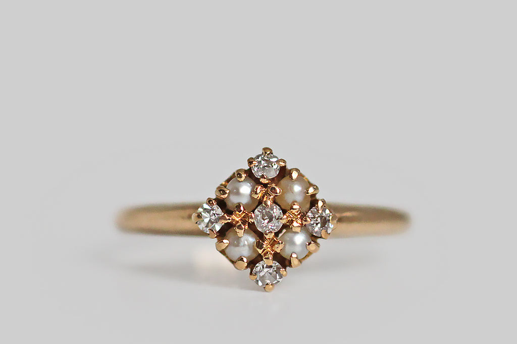 A late Victorian diamond and seed pearl cluster ring, with outstanding proportion and balance. This dainty love is modeled in 14k yellow gold. Its head is a thoughtfully-made, equilateral diamond, that holds within it the ring's five white diamonds and four natural seed pearls. There is a subtle cruciform shape implied by the diamond layout, and the ring's centermost prongs come together to give the impression of small flowers. The ring's  integral, half-round shank tapers toward the base. 