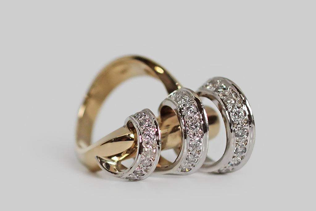 A vintage modernist ring, modeled substantially in 14k gold, whose unusual figure can be compared to a diamond-encrusted cyclone. The ring head’s open, spiraling white gold form whorls around a weighty, diagonally-placed, yellow gold rod— the graduating white gold form is highly-dimensional and is enlivened by many bead-set white diamonds. 