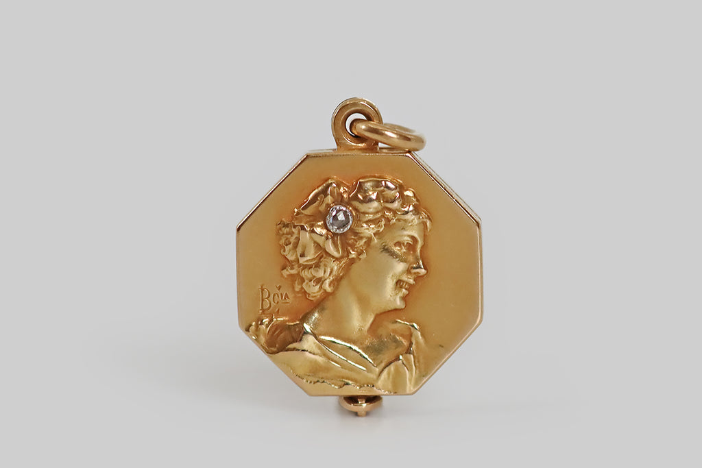 Poor Mouchette | Curated Antique Jewelry, Vintage Jewelry & Engagement Rings | Portland, Oregon | A lovely Art Nouveau-era slide locket, modeled in 18k yellow gold, whose petite octagonal face features a portrait of a smiling young woman, shown in profile. This portrait is especially charming and unusual for its photographic quality — the realistically-carved subject appears to have been caught in a laugh, her posture suggesting casual movement, rather than a pose.