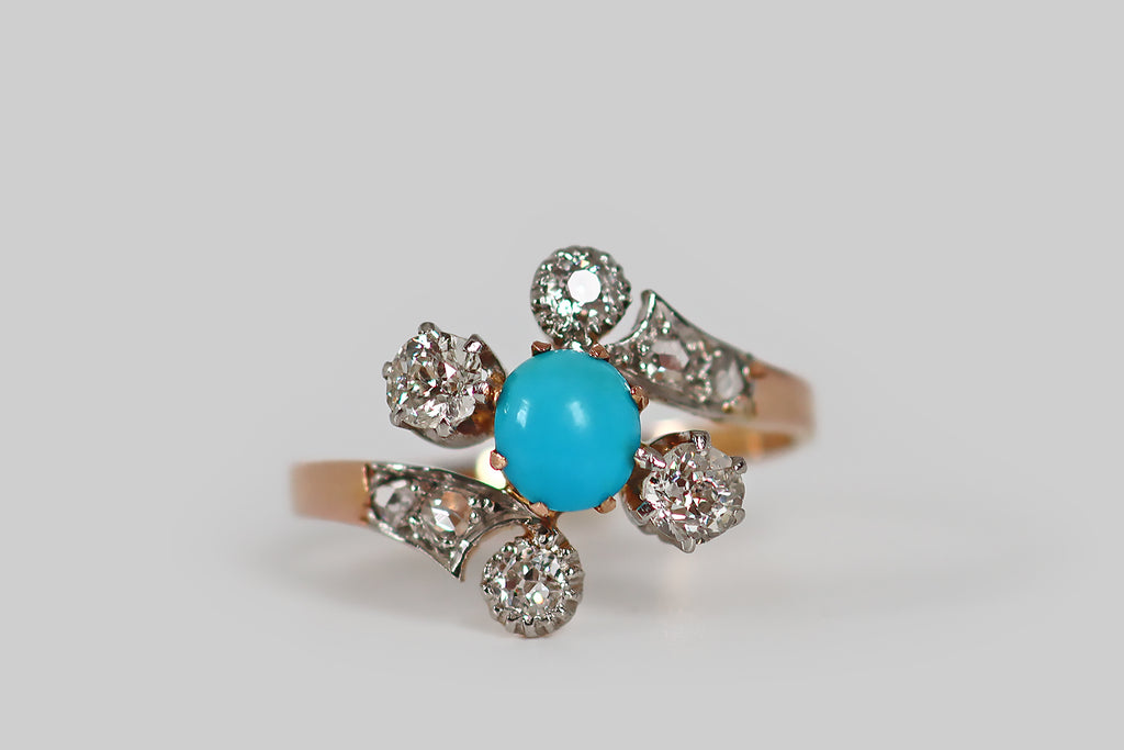 Antique Jewelry Portland, Vintage Jewelry Portland , Antique Engagement Rings | Poor Mouchette | A very sweet Victorian-era ring, modeled in 18k rose gold and platinum, whose bypass style shank cradles a diagonally-oriented, three-stone head. The ring's three primary stones (a bright-blue, oval, turquoise cabochon, and a pair of old European cut diamonds) are held in prong settings. The ring's curling shank features a pair of old European cut diamond