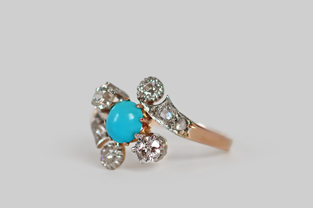 Antique Jewelry Portland, Vintage Jewelry Portland , Antique Engagement Rings | Poor Mouchette | A very sweet Victorian-era ring, modeled in 18k rose gold and platinum, whose bypass style shank cradles a diagonally-oriented, three-stone head. The ring's three primary stones (a bright-blue, oval, turquoise cabochon, and a pair of old European cut diamonds) are held in prong settings. The ring's curling shank features a pair of old European cut diamond