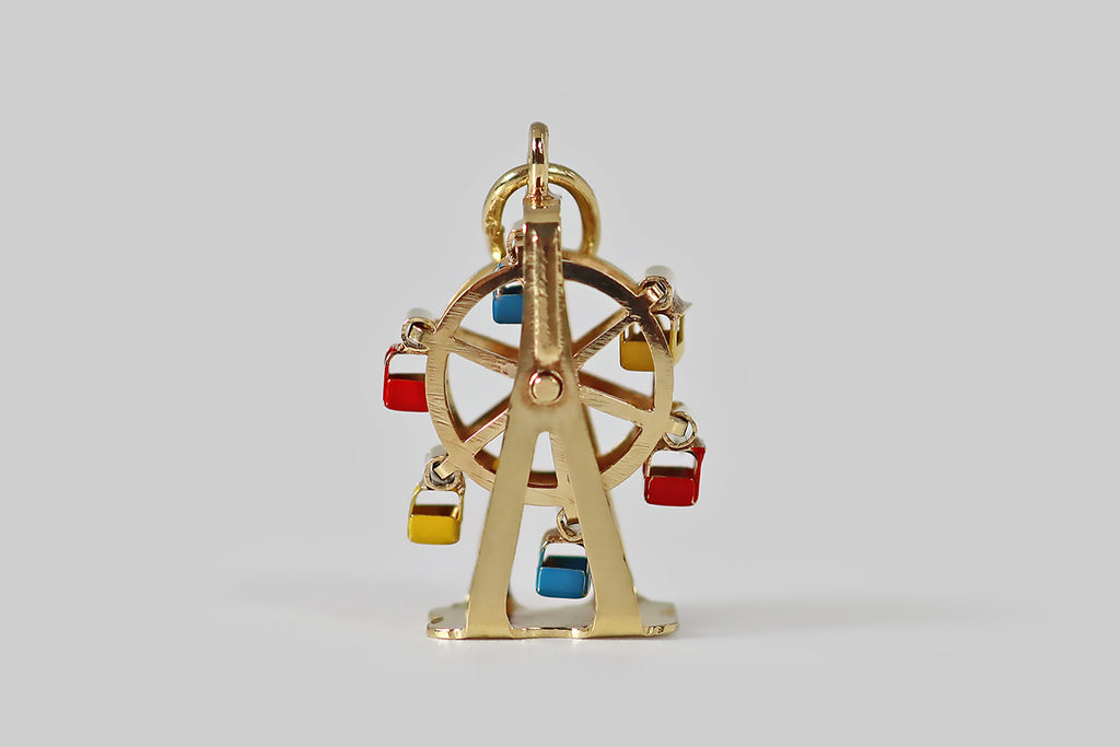 Antique Jewelry Portland, Vintage Jewelry Portland , Antique Engagement Rings | Poor Mouchette | A rare, mid 20th century, miniature charm, modeled as a ferris wheel, in 14k yellow gold. This gold ferris wheel spins smoothly on its center shaft, and its little blue, red, and yellow enameled carriages teeter independently, back and forth, as the wheel spins.