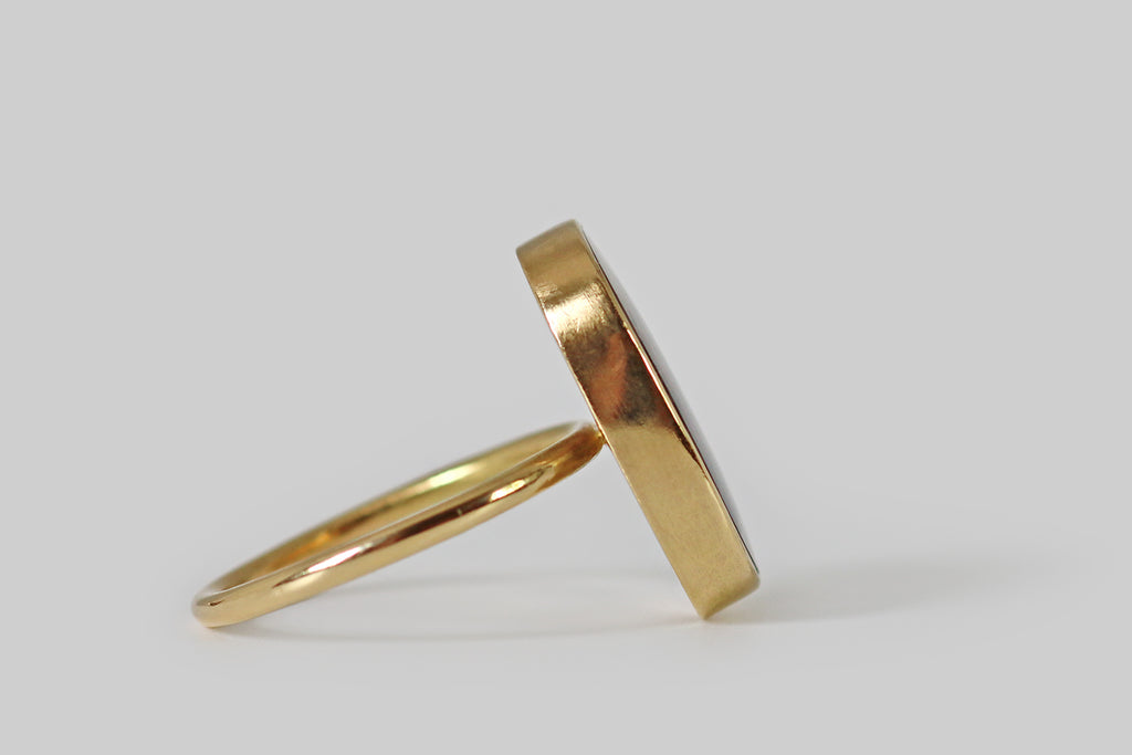 VPoor Mouchette | Curated Antique Jewelry, Vintage Jewelry & Engagement Rings | Portland, Oregon | A dendritic agate ring, fabricated in 18k yellow gold by the designer Gabriella Kiss. This gate has a serene presence— it is figured with feathery, red-brown plumes that appear frozen, mid-sway, inside its clear, chalcedony field. The agate is held in a smooth, low-profile, closed-back bezel that perches atop the ring’s slender, fully-round shank.
