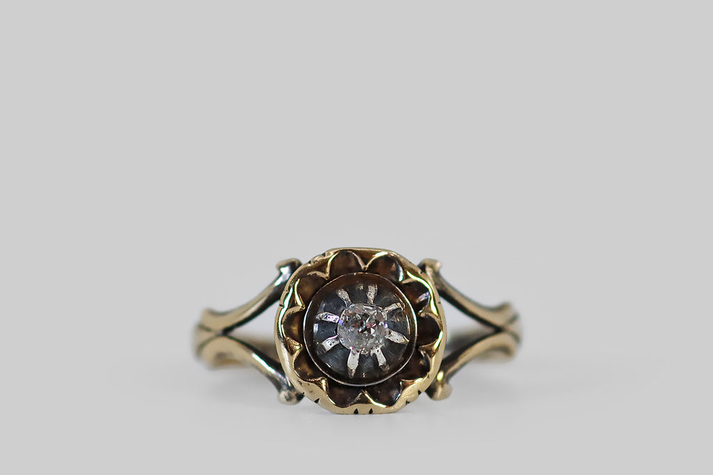 Antique Jewelry Portland, Vintage Jewelry Portland , Antique Engagement Rings | Poor Mouchette | A sweet Georgian era ring, modeled in 14k gold, whose little old mine cut diamond is held in a raised, sterling silver collet. This domed collet sits at the center of the ring face, which is scalloped in a manner that suggests a flower, or a small pastry. The petals of this pastry flower are deeply patinaed.