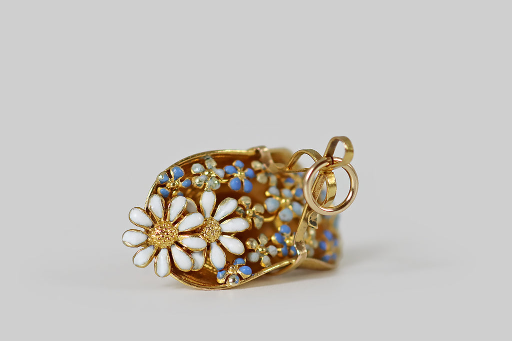 Poor Mouchette | Curated Antique Jewelry, Vintage Jewelry & Engagement Rings | Portland, Oregon | A darling turn of the century charm, modeled in 14k yellow gold as a straw hat, filled to overflowing with daisies and forget me nots! These enameled flowers are clustered naturalistically across the hat's opening, which is pinched closed by a curling ribbon handle. This miniature is especially realistic